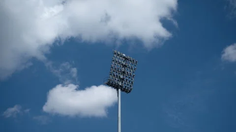 Stadium floodlight mast silhouetted against a cloudy blue sky. Concept of s.. Stock Footage 344050606
