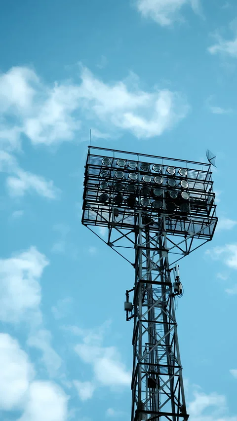 Stadium Floodlight Tower Against Blue Sky With Clouds. 動画素材 345015487