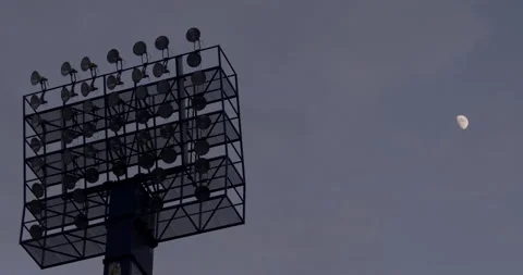 STADIUM FLOODLIGHTS - MOON IN BACKGROUND Stock Footage 140802199