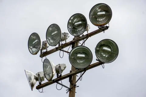 Stadium halogen lighting device against a white sky Stock Photos