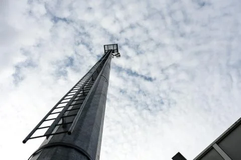 Stadium light pole with cloudy sky Stock Photos