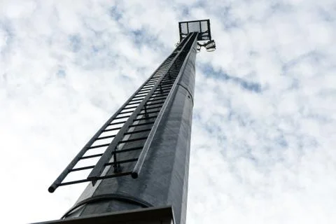 Stadium light pole with cloudy sky Stock Photos