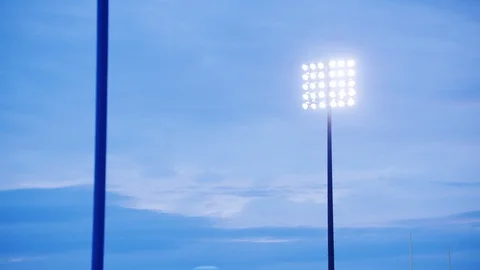 Stadium lights against an evening sky. Video stock 102796389
