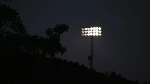 Stadium lights over a hill at night Stock Footage 103868627