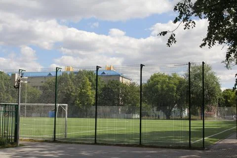 Stadium. School stadium. Empty stadium near the school. Stadium grid. Stock Photos