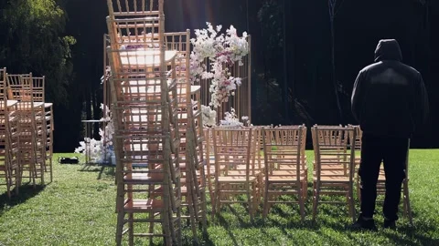 The staff arranges the chairs for the wedding Stock Footage 260883798