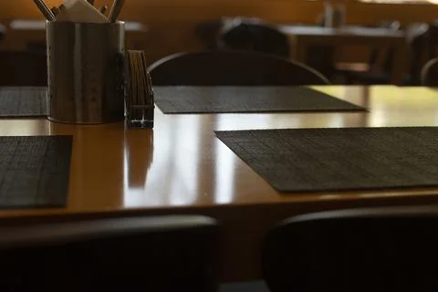 Staff arranging tableware with gentle lighting and calm atmosphere Stock Photos