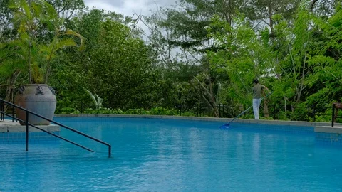 The staff cleaned up the blue swiming pool 스톡 동영상 108680897