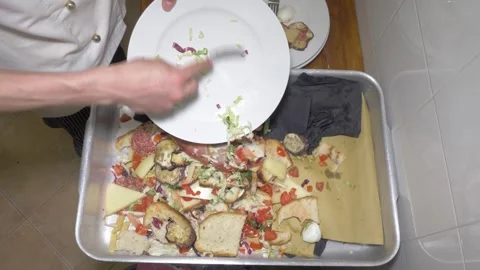 Staff Emptying Many Plates Into a Big Tray at a Large Catering Event Stock Footage 336793589