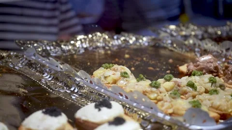 Staff hand placing warm tapas with tongs during premium catering service Stock Footage 337971444