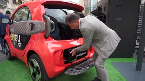 The staff is introducing How to replace the battery of  electric vehicle Stock Footage 168471085