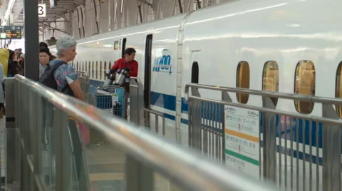 Staff loading items onto a Shinkansen Train, Shin-Osaka, Japan Stock Footage 52384767