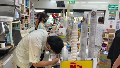 Staff making beverage for customers at convenient store, Bangkok Stock Footage 196266688