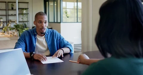 Staff member sliding form to client at office table, man taking pencil and Stock Footage 334924390