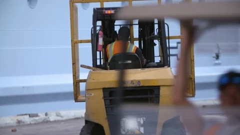 Staff members aligning container cage with help of forklift in Terminal 25 Stock Footage 116417238