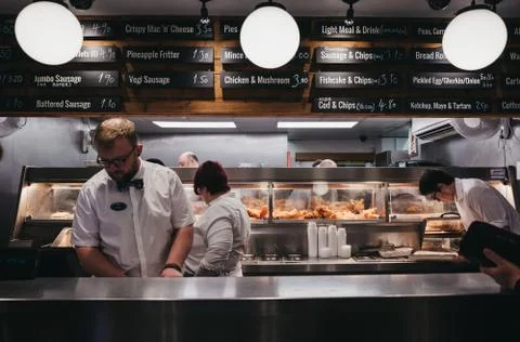 Staff serving fish and chips inside French's fish and chip shop in Wells-next Stock Photos