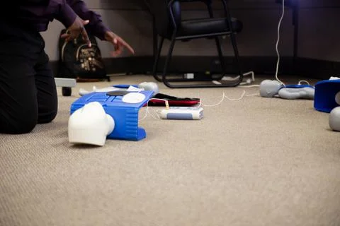 Staff setting AED machine to practice first aid Stock Photos