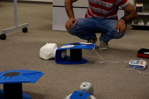 Staff setting AED machine to practice first aid Stock Photos