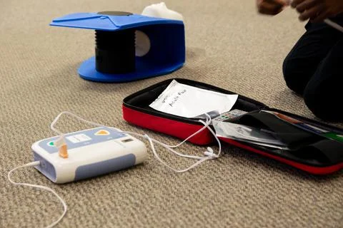 Staff setting AED machine to practice first aid Stock Photos