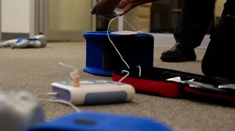 Staff setting AED machine to practice first aid Stock Photos