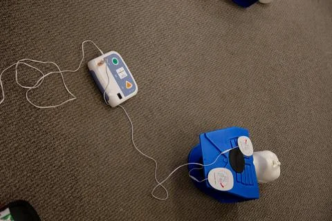 Staff setting AED machine to practice first aid Stock Photos
