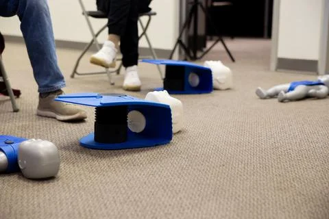 Staff setting AED machine to practice first aid Stock Photos