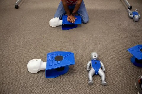 Staff training for CPR first aid with the AED. Stock Photos