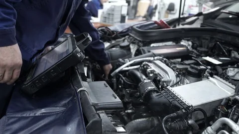 Staff updated the firmware software of the car at the station Stock Footage 71511458
