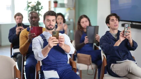 Staff workers take photos of presentation slide or scan QR code in classroom Stock Footage 341785783