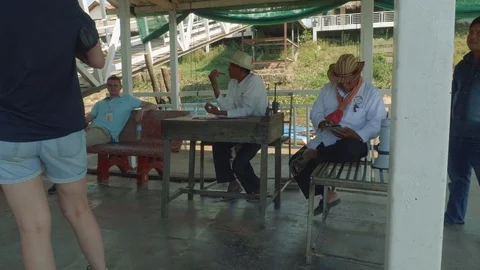 Staff working on floating station of lake sending and accepting boats for Stock Footage 86768346