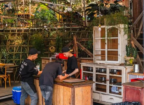 Staff Working at a Rustic Outdoor Cafe 写真素材