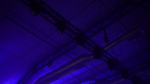 Stage ceiling lighting rig with industrial truss structure illuminated Stock Footage 322153372