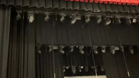 Stage curtains and lighting setup in a theater, showcasing a vibrant red an.. Stock Footage 340826389