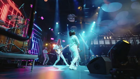 On stage during rock or pop music band concert, musicians and singers are Stock Footage 217803192