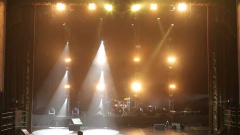Stage lighting. Light show. Musical instruments and drum set on an empty stage. Stock Footage 111197812