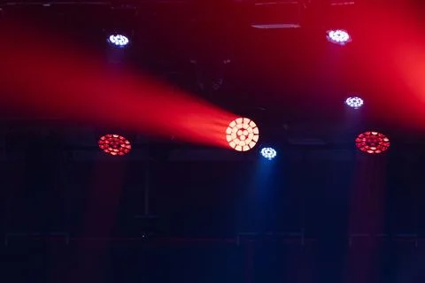 Stage lighting setup with red and blue beams illuminating a dark venue, fea.. Stock Photos