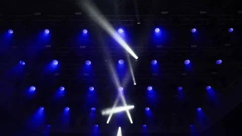 Stage lights and laser show, spotlights move to the music on a large concer.. Video stock 339380253