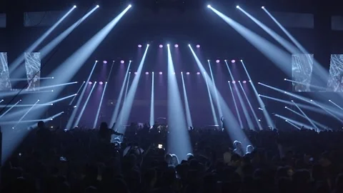 Stage lights in a concert crowd. Light beams at a music festival in slow motion 스톡 동영상 202309964