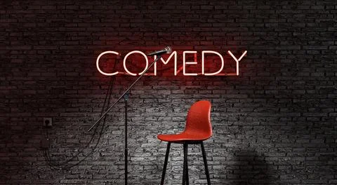 Stage lit by a spotlight and a red neon lamp with the word COMEDY Stock Photos