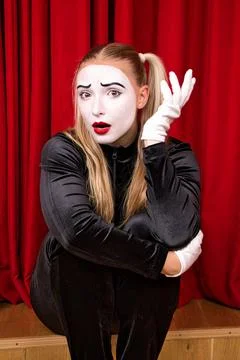 On stage is a pantomime artist with a surprised expression on his face. Stock Photos