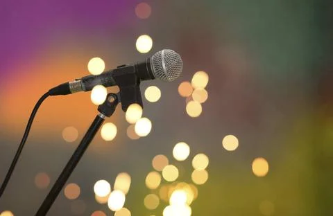 Stage retro microphone on a multicolored background in spots of golden bok... 스톡 사진