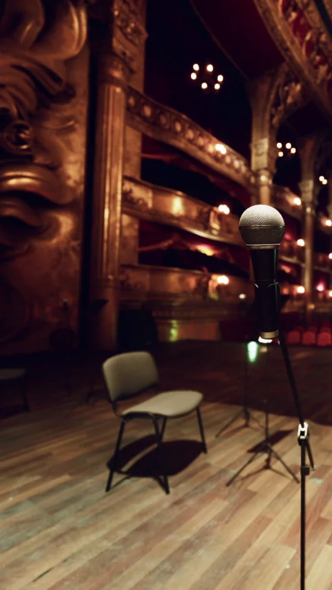 Stage setup with a microphone and empty chair in a theater Stock Footage 339508863