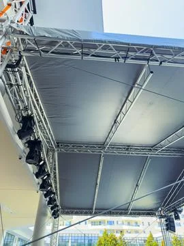 Stage setup shows a framework with lights at an outdoor event location duri.. Фото