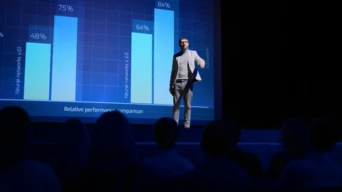 On-Stage: Speaker Does Presentation of the New Electronic Product, Shows Data Stock Footage 122810571