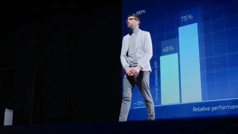 On-Stage Speaker Greets Audience Presentation of Technological Device, Show Data Stock Footage 122810443