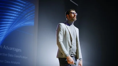 On-Stage Speaker Greets Audience Presentation of Technological Device, Show Data Stock Footage 122810723