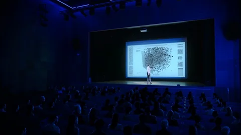 On Stage: Successful Tech Start-up CEO Shows Cinema Screen With Neural Network Stock Footage 126502266