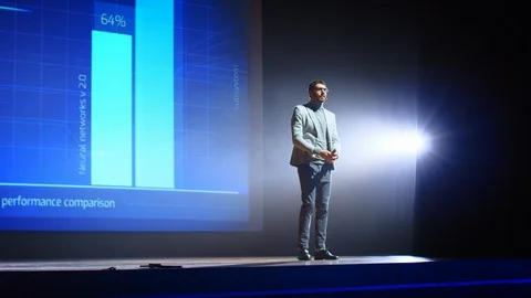 On Stage Visionary Speaker Presents Technology Product, Uses Remote Control Stock Footage 122814178