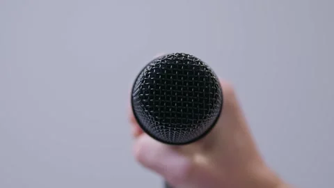 Stage vocalists microphone against a white background, close-up shot Stock Footage 289630892