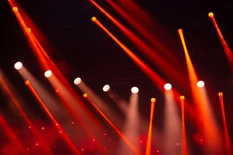 Stage white and red light beams on dark background. Stage lighting for concer Stock Photos
